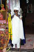 Stone church at Lalibela. Priest shows holy crosses. North,  Ethiopia.