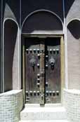 Traditional door at Kashan town. You can see two types of doorbells (they have different sound) - one for men and one for women.  Iran.