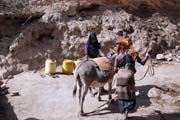 People are going for water, which is retrieving by men-chain from 20m deep wellp. Singing well in Dublock. Ethiopia.
