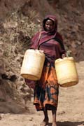 People are going for water, which is retrieving by men-chain from 20m deep wellp, Singing well in Dublock. Ethiopia.