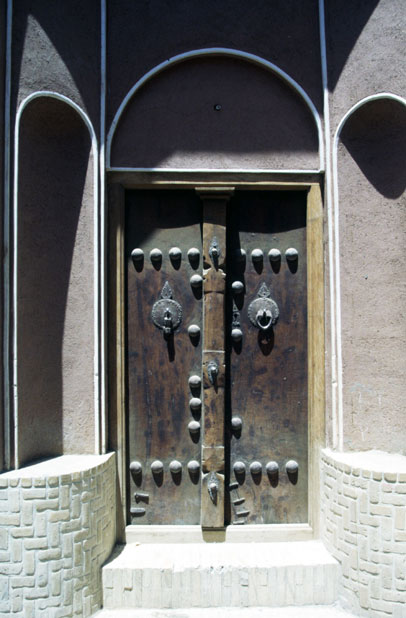 Traditional door at Kashan town. You can see two types of doorbells (they have different sound) - one for men and one for women.  Iran.