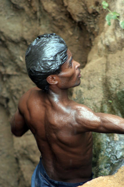 The water is retrieving from 20m deep well by men-chain to small reservoir. Men are singing for better synchronization. Singing well, Dublock. South,  Ethiopia.