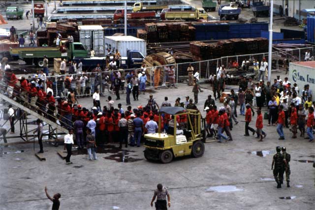 Porters at Sorong harbor are running to Pelni ship. Papua,  Indonesia.